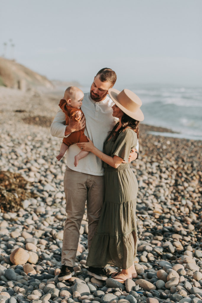 new family with newborn on a beach in Carlsbad